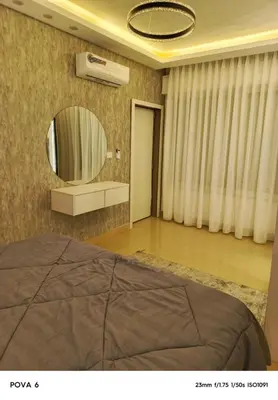a bedroom with a bed and a mirror at Al yaqoot apartment in Amman