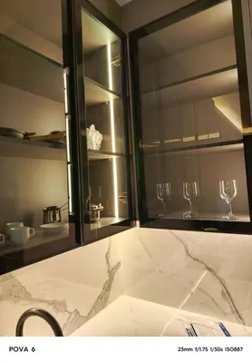 a kitchen with two wine glasses in a window at Al yaqoot apartment in Amman
