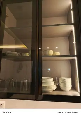 a glass cabinet with plates and dishes in it at Al yaqoot apartment in Amman