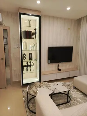 a living room with a tv and a couch and a table at Al yaqoot apartment in Amman