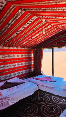 a room with two beds in a tent at Desert Nights camp in Aqaba