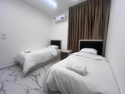 a hotel room with two beds and a window at Bellagio Chaleht in Al Rama