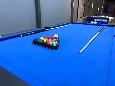 a pool table with a cue and balls on it at Bellagio Chaleht in Al Rama