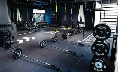 a gym with several rows of barbells in a room at Le Shot tours Hotel in Al Jafr
