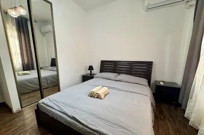a bedroom with a bed and a large mirror at Central Budget Stay in Amman