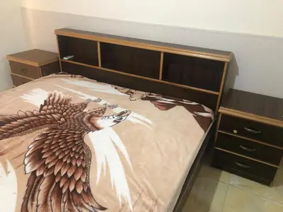 a bedroom with a bed with a picture of aoster on it at Irbid in Irbid
