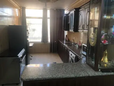a kitchen with a refrigerator and a counter top at Irbid in Irbid