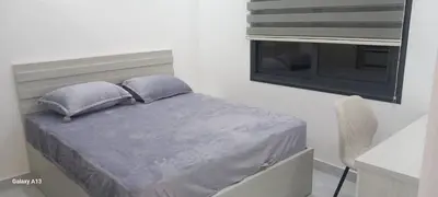 a bed with two pillows and a window in a room at غزو 15 in Irbid