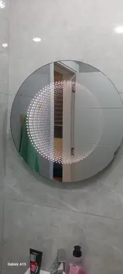 a large circular mirror in a room with a table at غزو 15 in Irbid