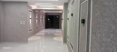 a hallway in a building with white floors and walls at غزو 15 in Irbid