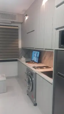 a kitchen with a washing machine on a counter at غزو 15 in Irbid