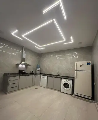 a kitchen with a refrigerator and a washer at Luxury Haven villa in Jerash
