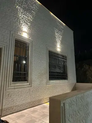 a white building with a window and a fence at Luxury Haven villa in Jerash