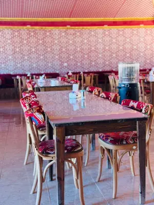 a wooden table with chairs and a tableasteryasteryasteryasteryasteryasteryasteryastery at Rum Dreamland luxury camp in Wadi Rum