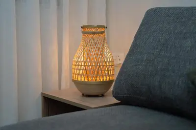a lamp sitting on a table next to a bed at Maria Suites 2 in Aqaba