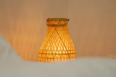 a yellow wicker lamp hanging from a wall at Maria Suites 2 in Aqaba