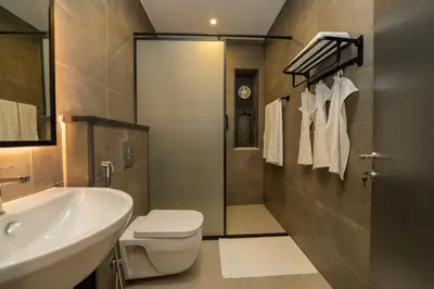 a bathroom with a white toilet and a sink at Maria Suites 1 in Aqaba