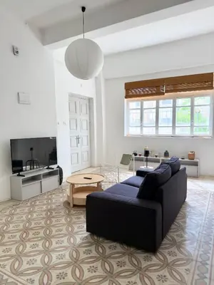 a living room with a couch and a table at Turath by Badiya 2BR Apt In Luweibdeh in Amman