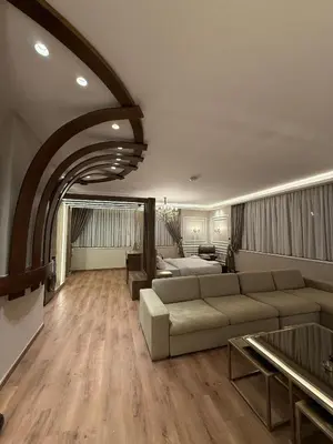 a large living room with a couch and a bed at amazing rooftop studio at abdoun 702 in Amman