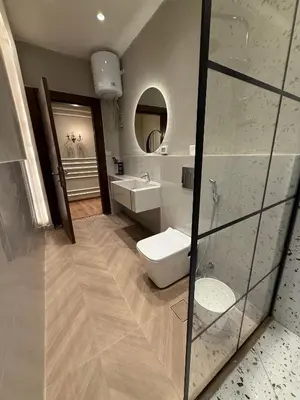 a bathroom with a toilet and a sink and a mirror at amazing rooftop studio at abdoun 702 in Amman