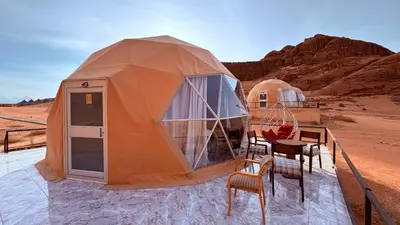a tent in the desert with a table and chairs at HAGIA SOPHIA lUXURY CAMP in Disah