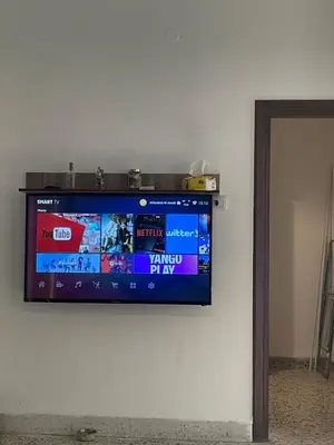 a flat screen tv hanging on a wall at Central apartment with beautiful view in Amman