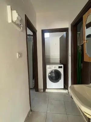 a bathroom with a washing machine in a room at Central apartment with beautiful view in Amman