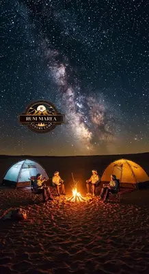 a group of people sitting around a camp fire on the beach at RUM MAREA lUXURY CAMP in Wadi Rum