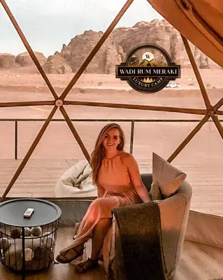 a woman sitting in a chair in a tent at RUM MAREA lUXURY CAMP in Wadi Rum