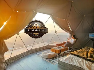 a man sitting in a room in a tent at RUM MAREA lUXURY CAMP in Wadi Rum