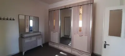 a bathroom with a mirror and a dresser and a sink at Two Palms Housing in Jerash