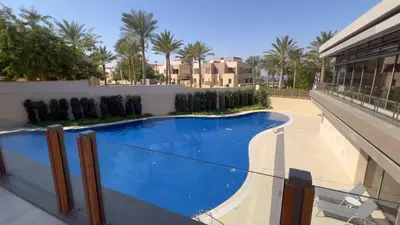 a swimming pool on the side of a building at Luxury Suite in Aqaba AlRaha Village Marsa Zayed in Aqaba