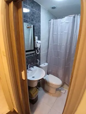 a bathroom with a white toilet and a sink at Kahraman Amman Hotel in Amman