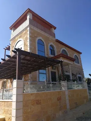 a large brick building with a roof at Green Hills in Ajloun