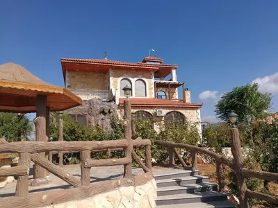 a house with a wooden fence in front of it at Green Hills in Ajloun