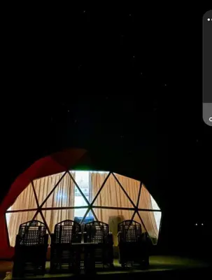 a group of chairs in a room with a window at Camb wadi Rum in Disah