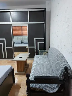 a bedroom with a bed and a table in it at Small huose in Amman