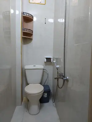 a small bathroom with a toilet and a shower at Small huose in Amman