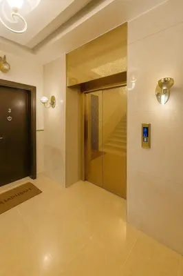 a hallway with a glass door and a staircase at Elite Apartment Compound 1 in Amman