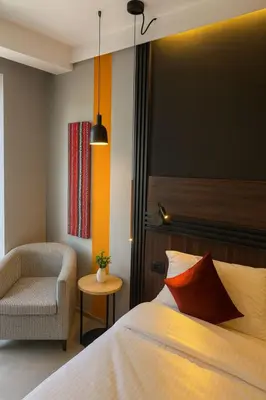 a hotel room with a bed and a chair at Crystal Collection Hotel in Amman