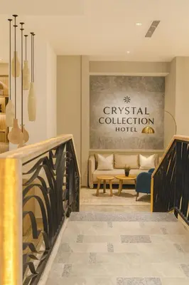 a lobby of a hotel with a bench and a table at Crystal Collection Hotel in Amman