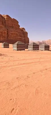 a row of benches sitting in the desert at Bedouin Horizons in Wadi Rum