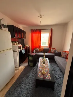 a living room with a couch and a table at Al Jubaiha cozy studio 2 in Amman