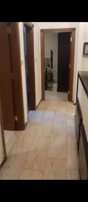 a hallway of a room with a tile floor at عمان شارع مكه in Amman