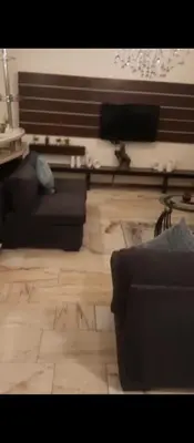a living room with two couches and a wooden floor at عمان شارع مكه in Amman
