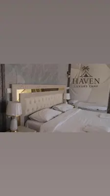 a bedroom with two beds with a sign that sayshaven luxury spa at Haven Luxury Camp in Aqaba