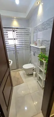 a bathroom with a toilet and a shower and a sink at Irbid irbid alrazi st in Irbid