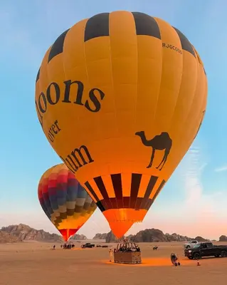 a group of hot air balloons in the desert at Wadi Rum Emerald Camp in Wadi Rum