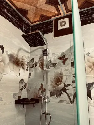 a room with a wall with flowers and a surfboard at Wadi Rum Emerald Camp in Wadi Rum
