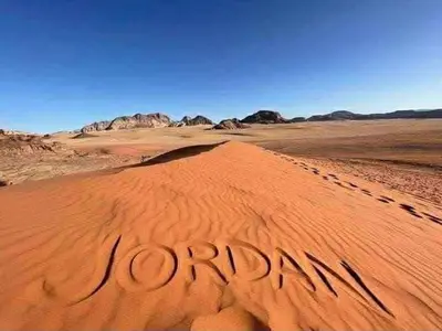 a desert with the word opportunity written in the sand at Wadi Rum cloud in Ma‘ān